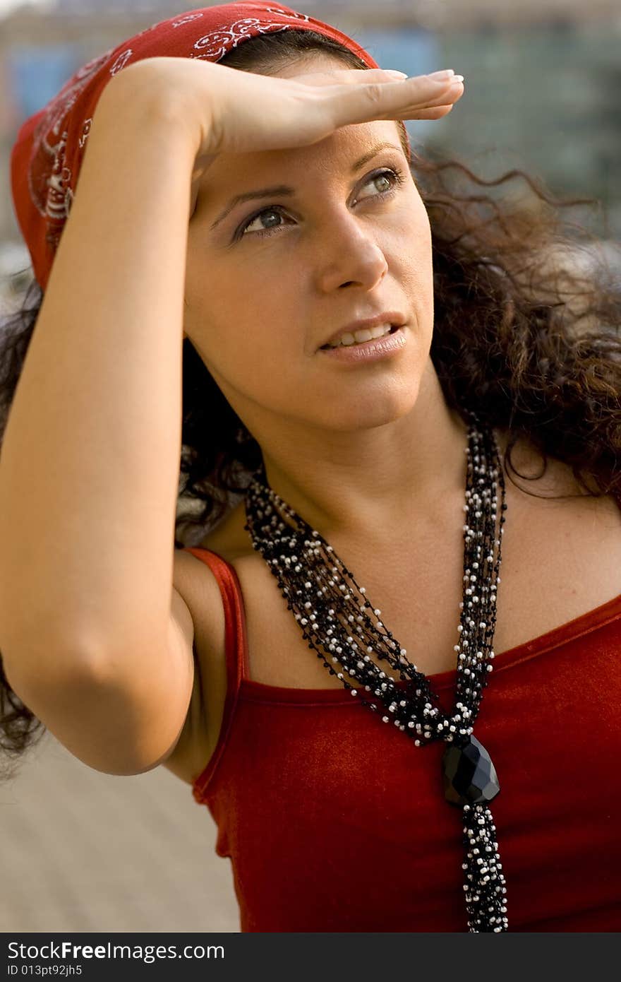 Outdoor portrait of happy woman in red