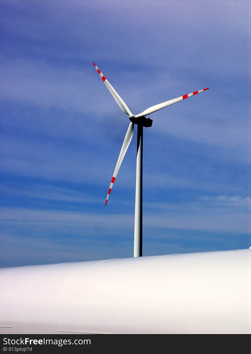 Windmil and a part of column for another one on the blue sky. Windmil and a part of column for another one on the blue sky