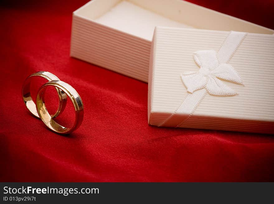 Wedding rings on red background