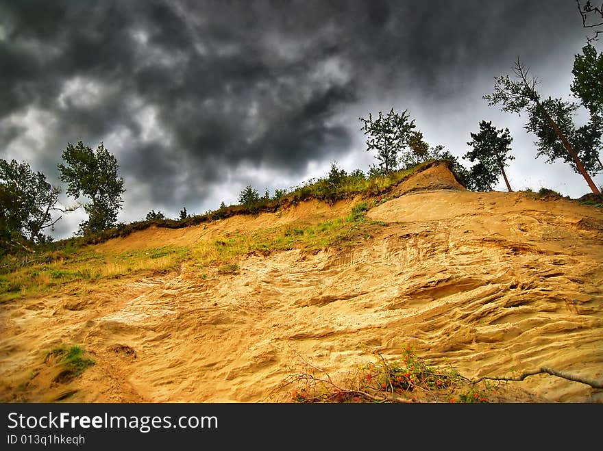 Sandy cliff on stormy clouds. Sandy cliff on stormy clouds.