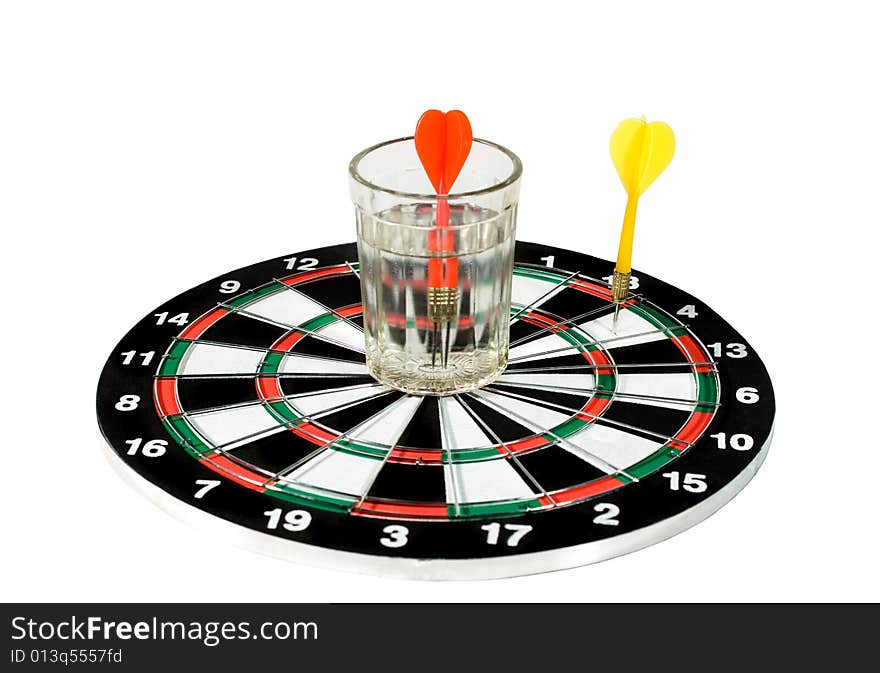 Glass of water and two darts on a dartboard (isolated on white). Glass of water and two darts on a dartboard (isolated on white)