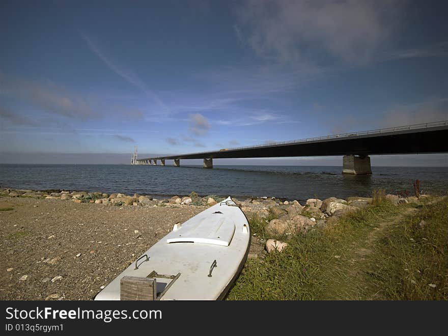 The Great Belt Bridge running between Danish islands Zealand and Funen. - Focus on the boat. The Great Belt Bridge running between Danish islands Zealand and Funen. - Focus on the boat.