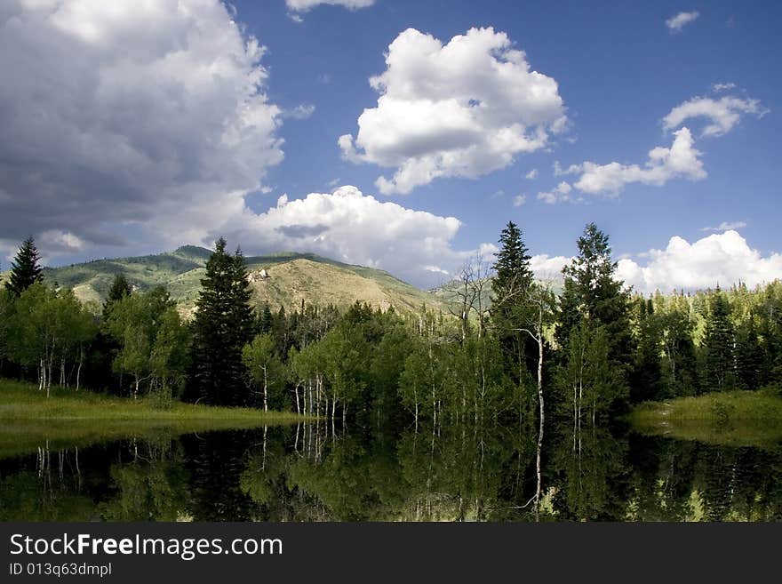 Rocky Mountains in the spring showing trees and snow capped mountains. Rocky Mountains in the spring showing trees and snow capped mountains