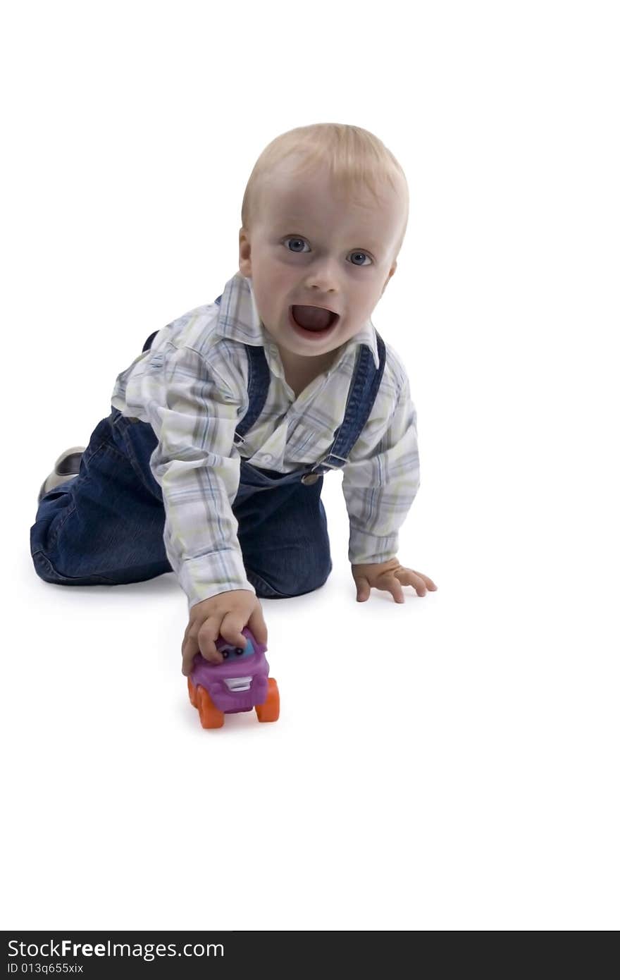 Merry boy playing with toy - car on white background. Merry boy playing with toy - car on white background