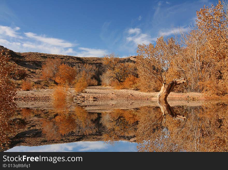 View of the red rock formations in San Rafael Swell with blue sky�s and water reflections. View of the red rock formations in San Rafael Swell with blue sky�s and water reflections