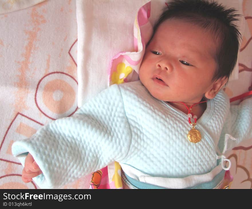 Infant and accessories on a bed