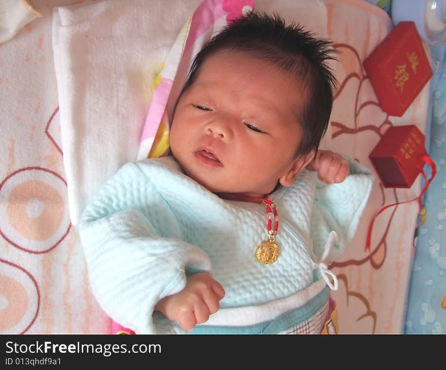 Infant and accessories on a bed