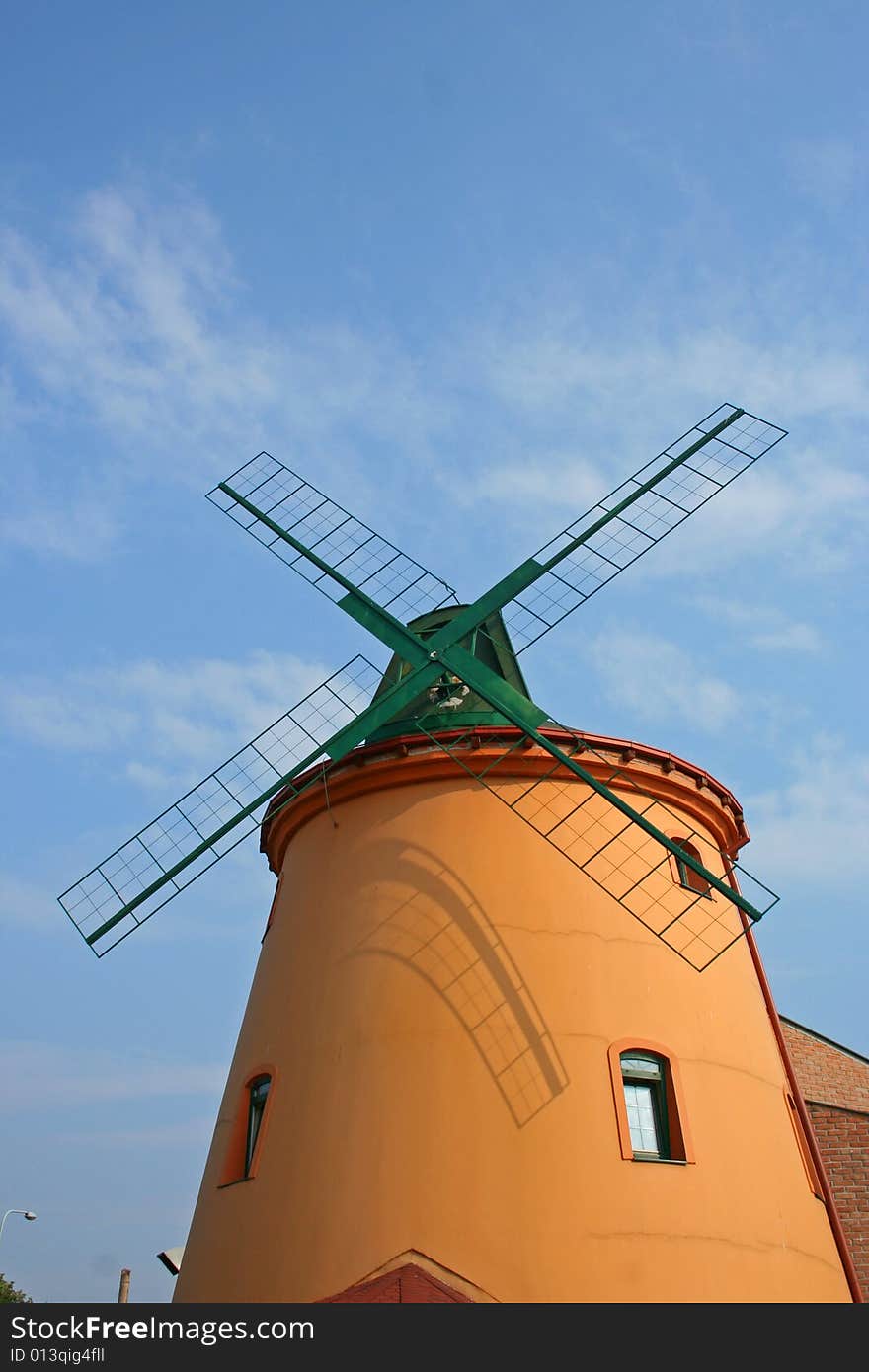 New windmill tower with four limbs on sky.