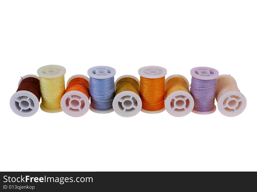 Line of colorful threads isolated on white background