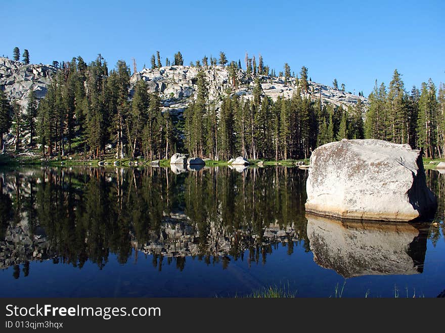 Mountain and rocks reflected in a lake. Mountain and rocks reflected in a lake