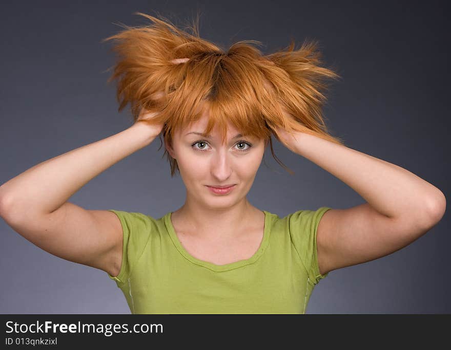 Portrait of the red-haired girl in a green T-shirt