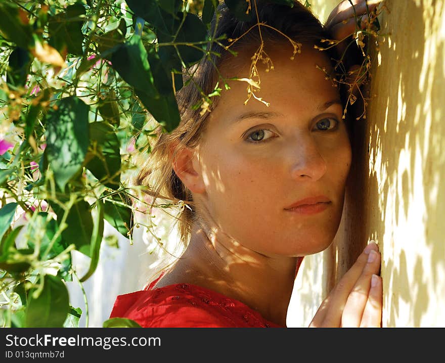 Portrait of young girl at a wall with plants. Portrait of young girl at a wall with plants