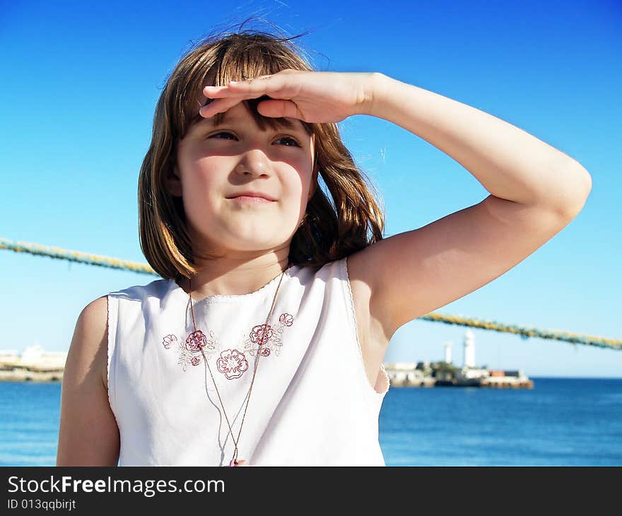 Girl in a port. Looking into the distance