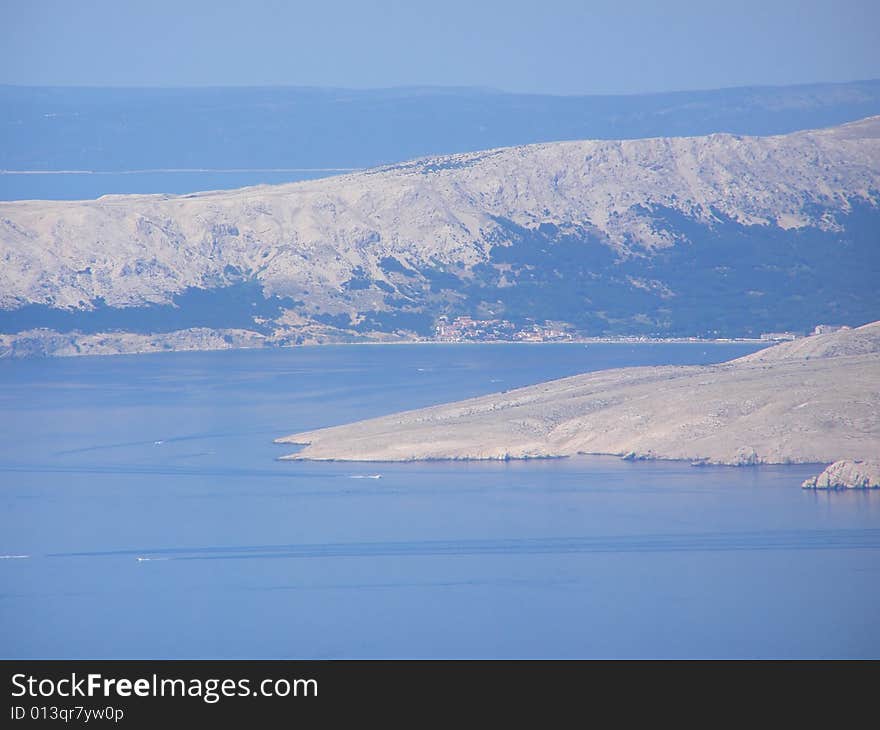 Croatia - view from the Velebit Mountain (Vratnik Pass) to the Adriatic Sea and Kvarner Bay - islands of Krk and Cres in the background. Croatia - view from the Velebit Mountain (Vratnik Pass) to the Adriatic Sea and Kvarner Bay - islands of Krk and Cres in the background