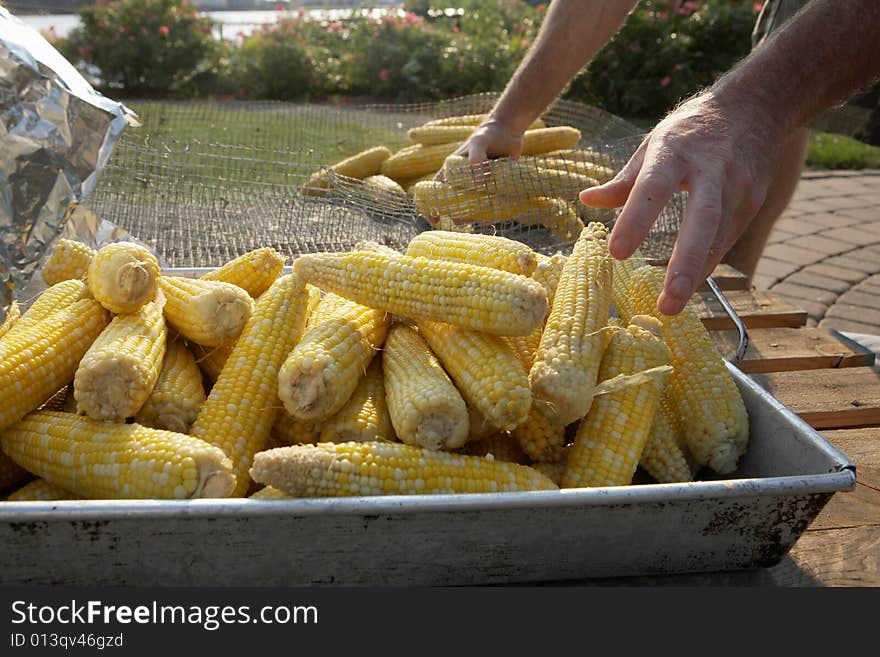 Closeup of preparation of corn on the cob at barbecue