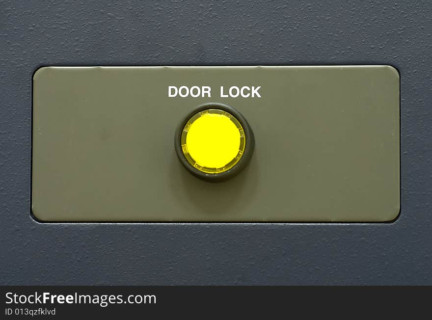 Steel plain surface with yellow button. Steel plain surface with yellow button