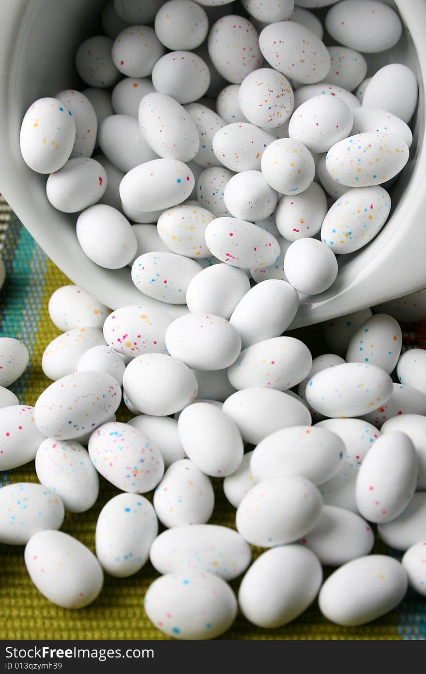 Miniature speckled easter eggs in a green bowl