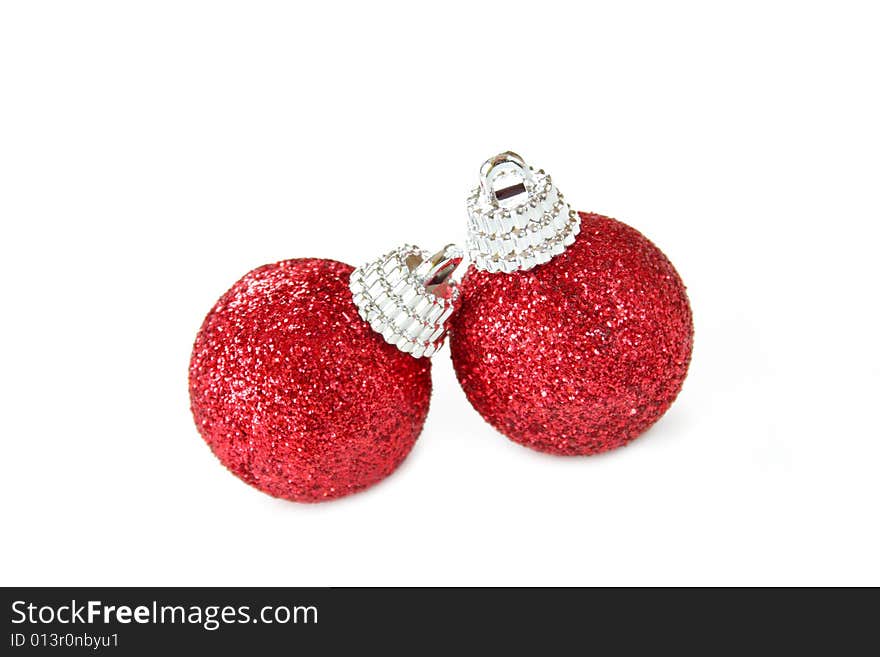 Two red Christmas ornaments made of glitter and isolated on a white background.