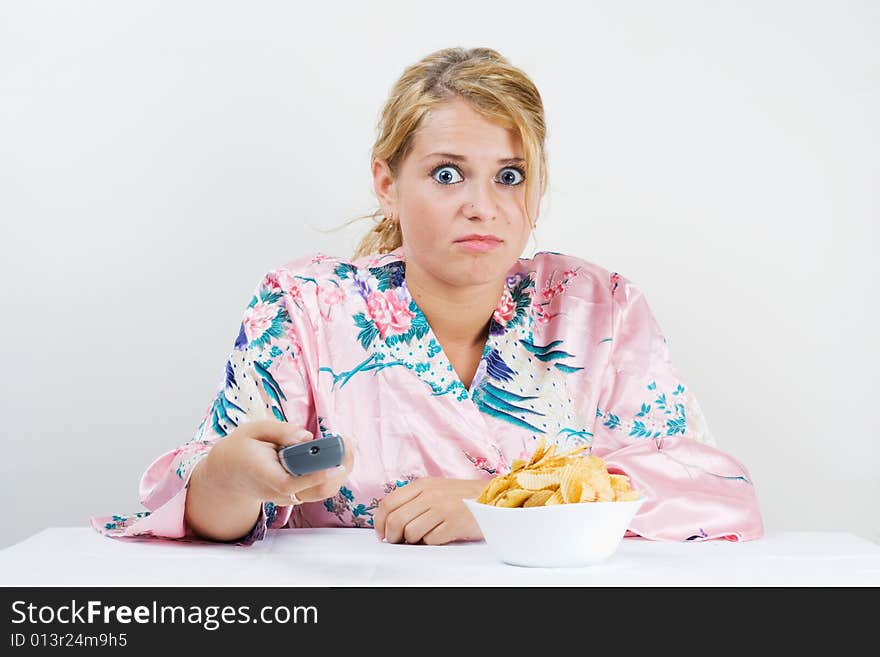 Young cute girl watching TV and very scared. Young cute girl watching TV and very scared.