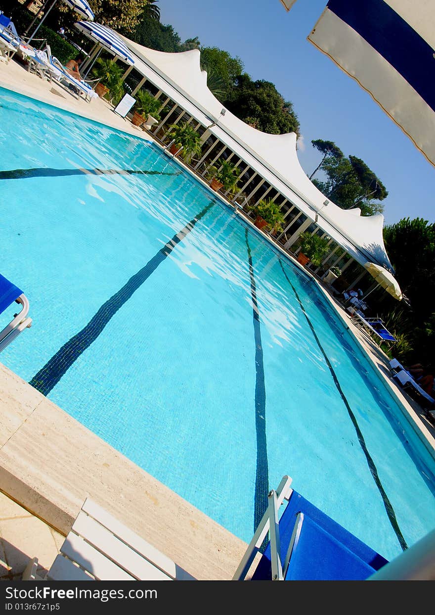 A beautiful shot of a pool in an hotel. A beautiful shot of a pool in an hotel