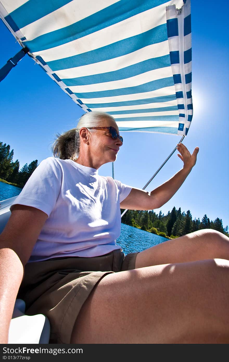 Senior woman in paddle boat on pond. Senior woman in paddle boat on pond