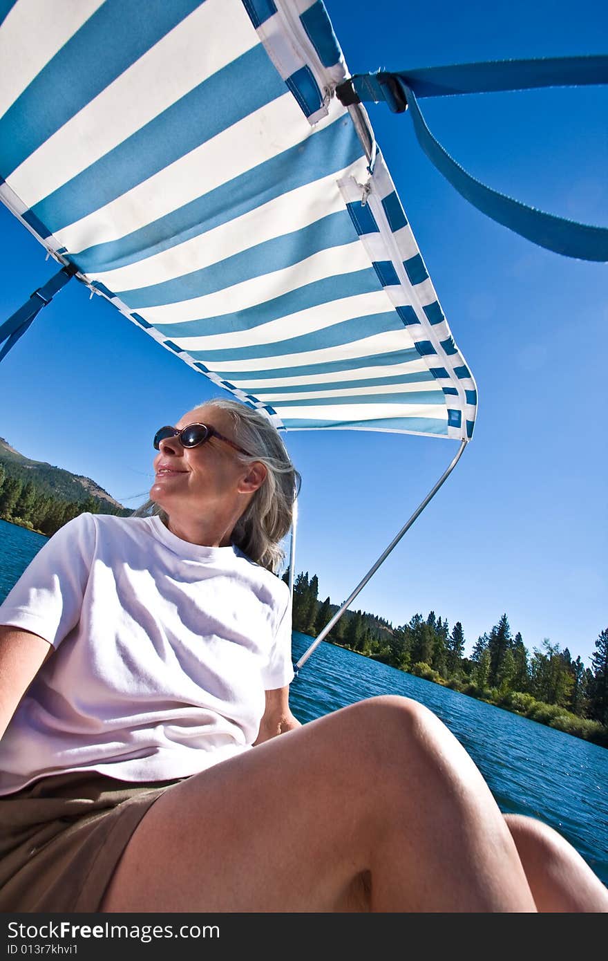 Senior woman in paddle boat on pond. Senior woman in paddle boat on pond