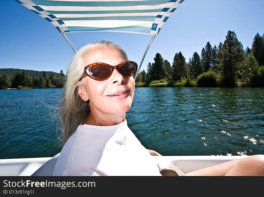 Senior woman in paddle boat on pond. Senior woman in paddle boat on pond