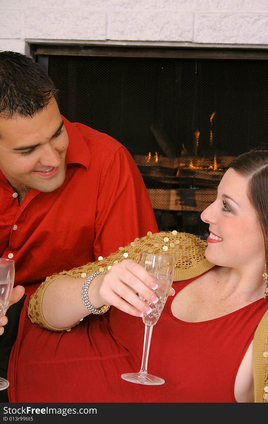 Romantic couple by fireplace vertical upclose