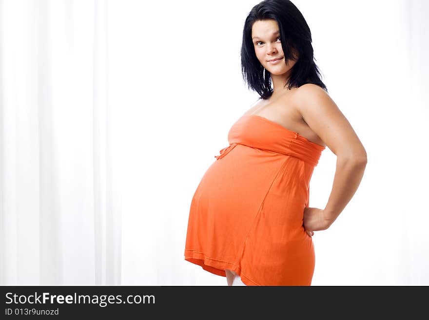 Young pregnant woman looking at camera. Young pregnant woman looking at camera.