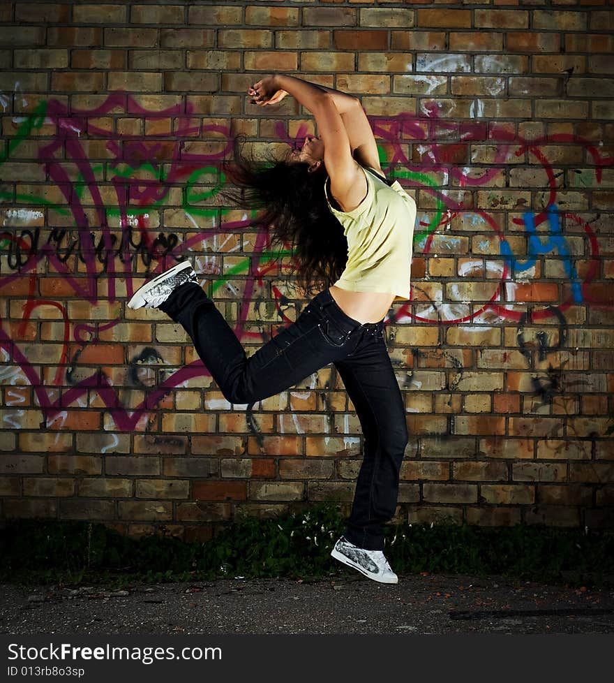 Young girl jumping against the wall. Young girl jumping against the wall.