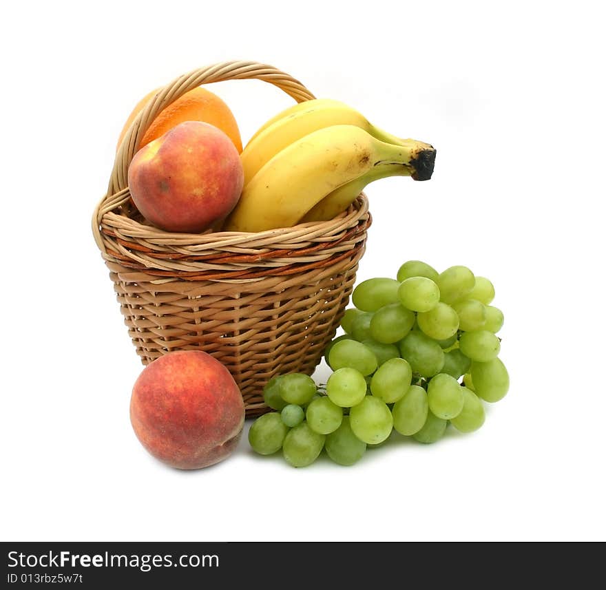 Tasty and beautiful fruit on a white background and a basket
