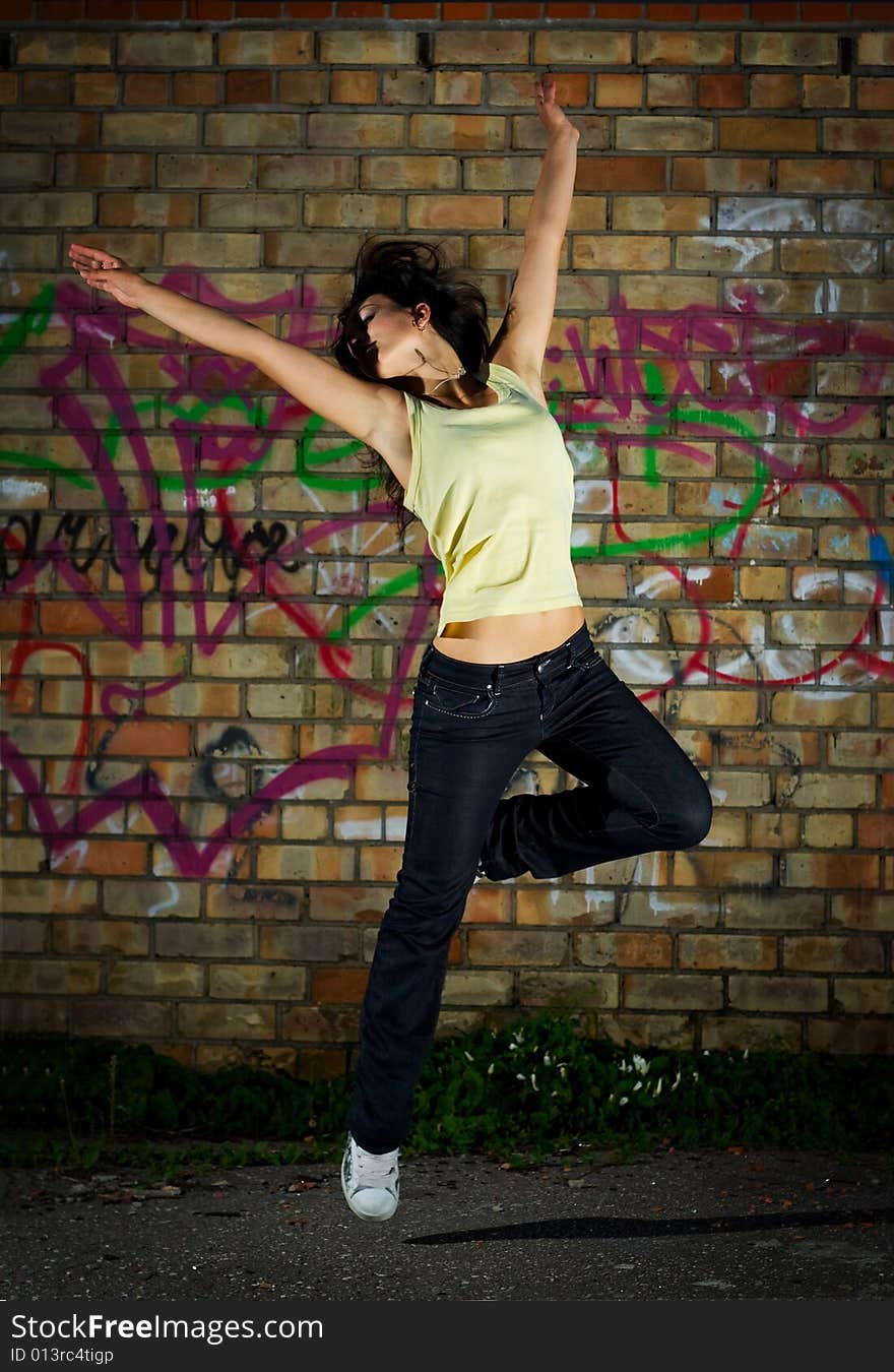 Young girl dancing against the wall. Young girl dancing against the wall.