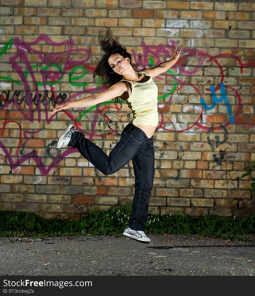 Young girl dancing against the wall. Young girl dancing against the wall.