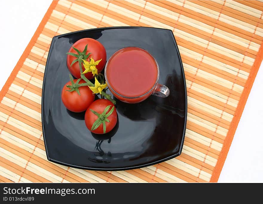 Black plate with red tomatoes