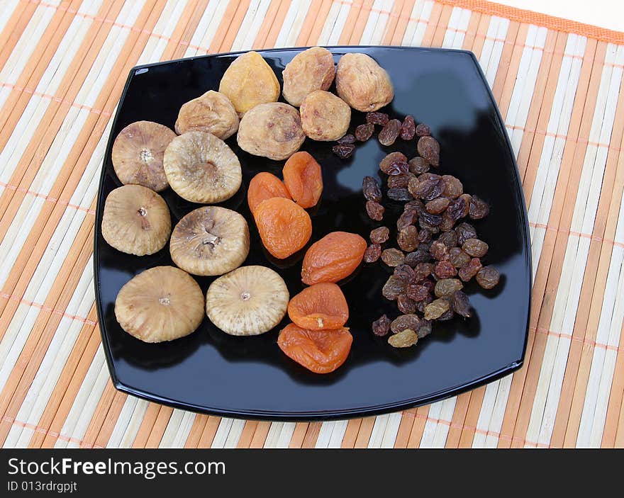 Fruit for compote on a white background with an orange striped napkin