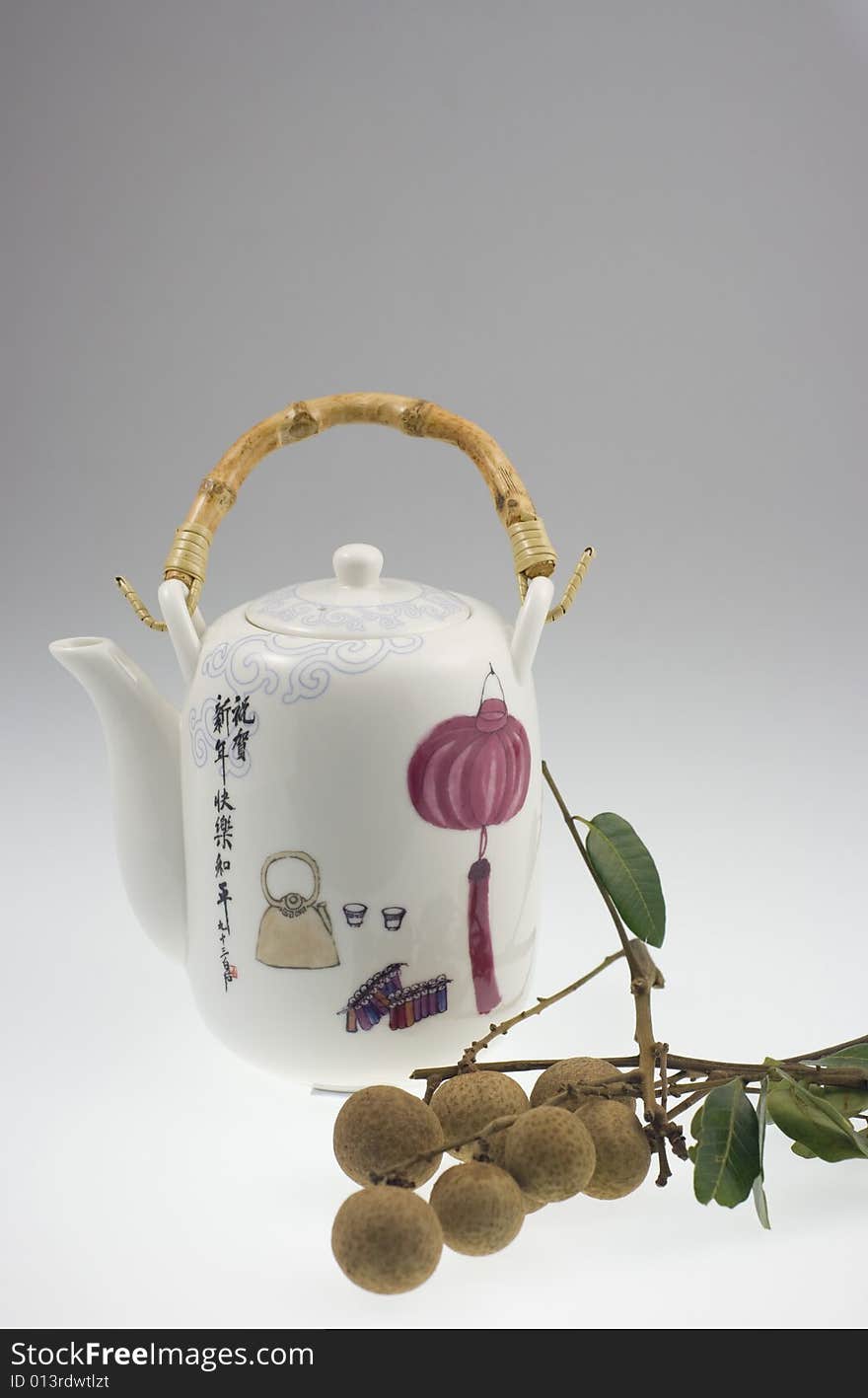 A Chinese pot with traditional Chinese painting and longan. A Chinese pot with traditional Chinese painting and longan