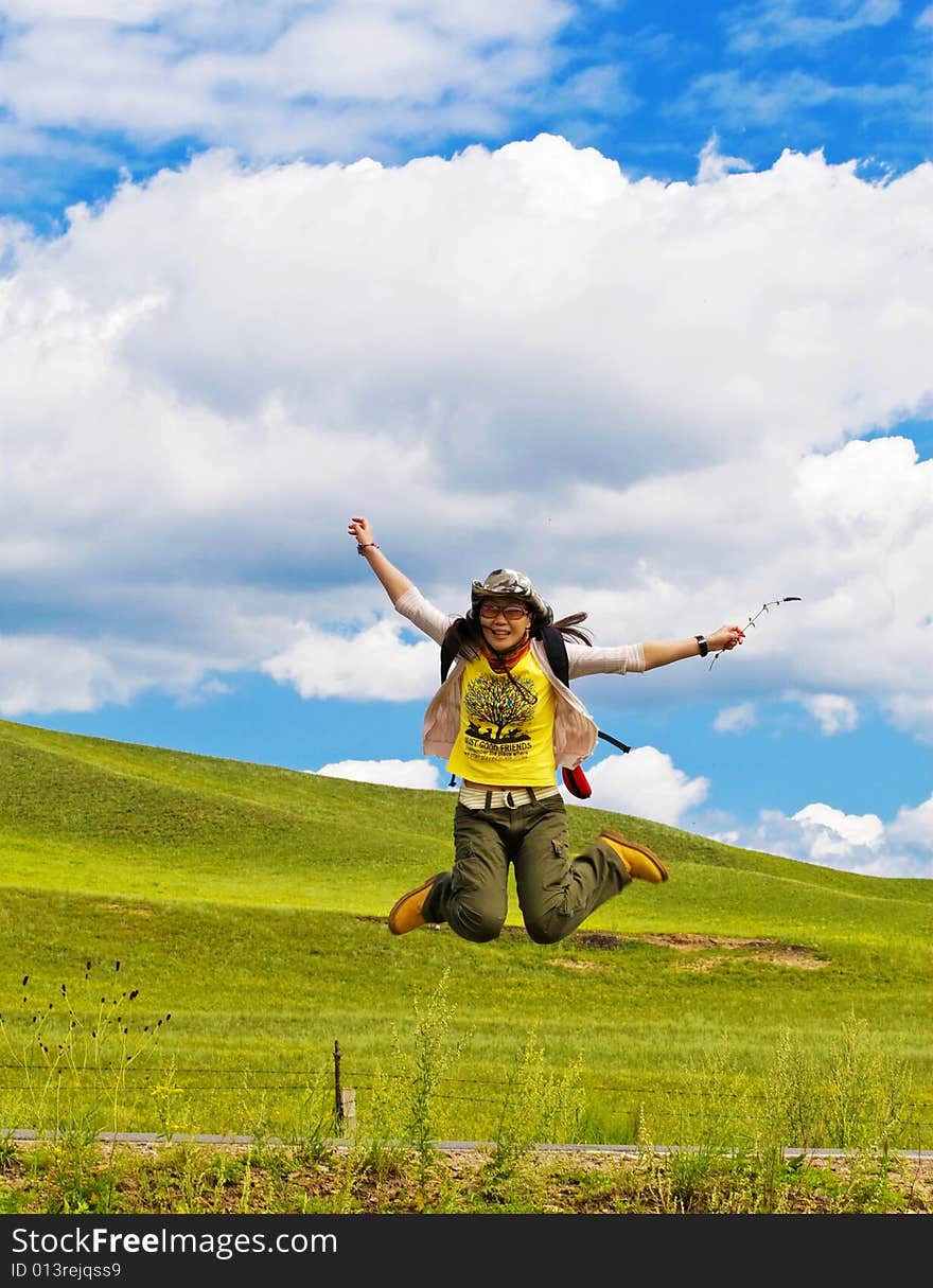 Happy girl on meadow against the blue sky and clouds. Happy girl on meadow against the blue sky and clouds