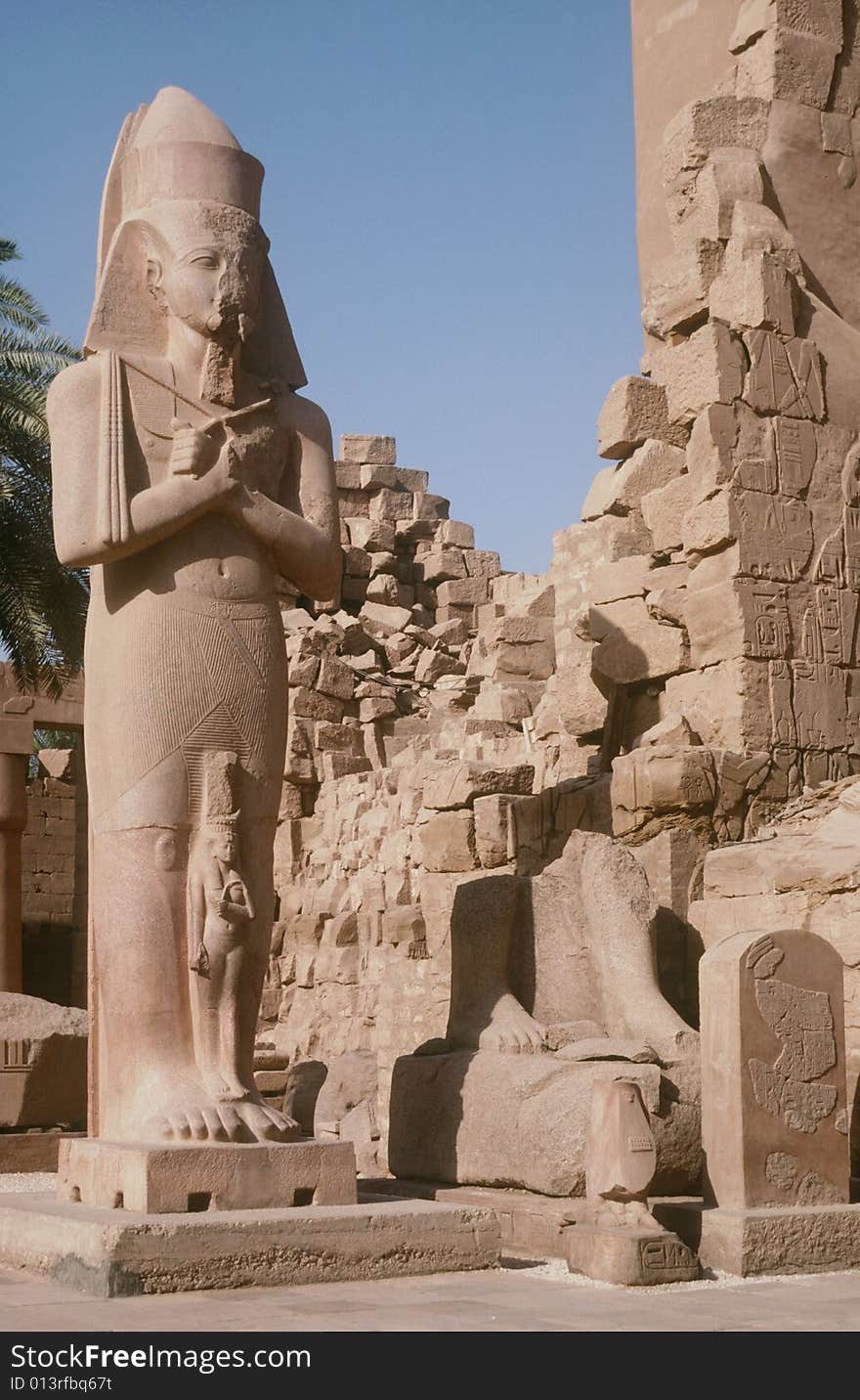 A colossus statue standing amongst the ruins of the Temples of Karnak in Luxor, Egypt. A colossus statue standing amongst the ruins of the Temples of Karnak in Luxor, Egypt.