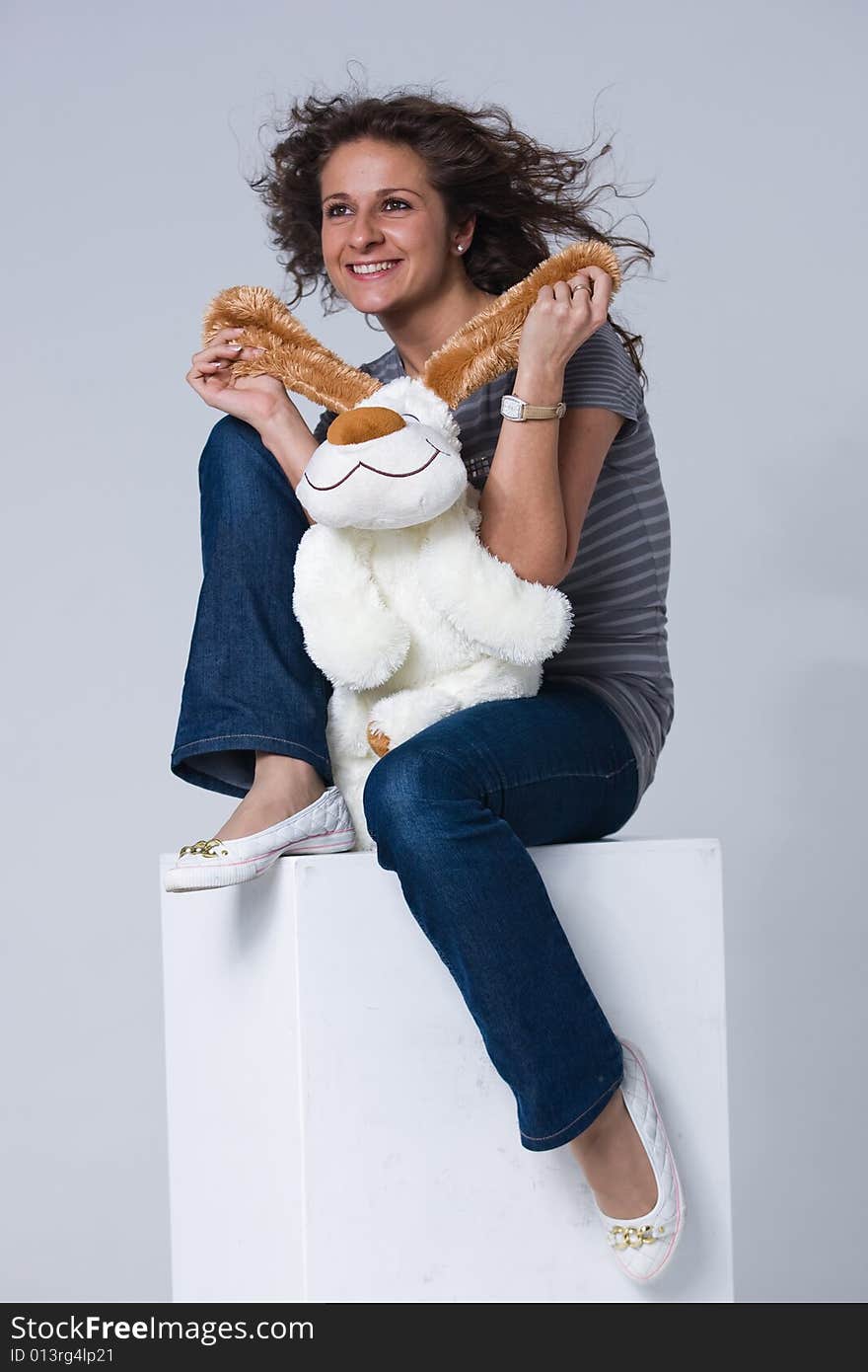 Smiling girl is sitting with a toy puppy. Smiling girl is sitting with a toy puppy