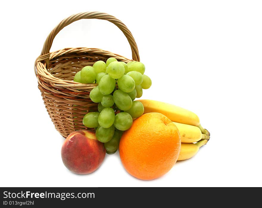 Peaches and orange in a yellow basket. Peaches and orange in a yellow basket