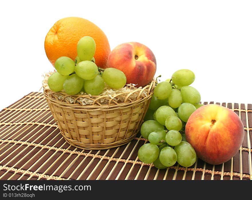 Peaches and orange in a yellow basket