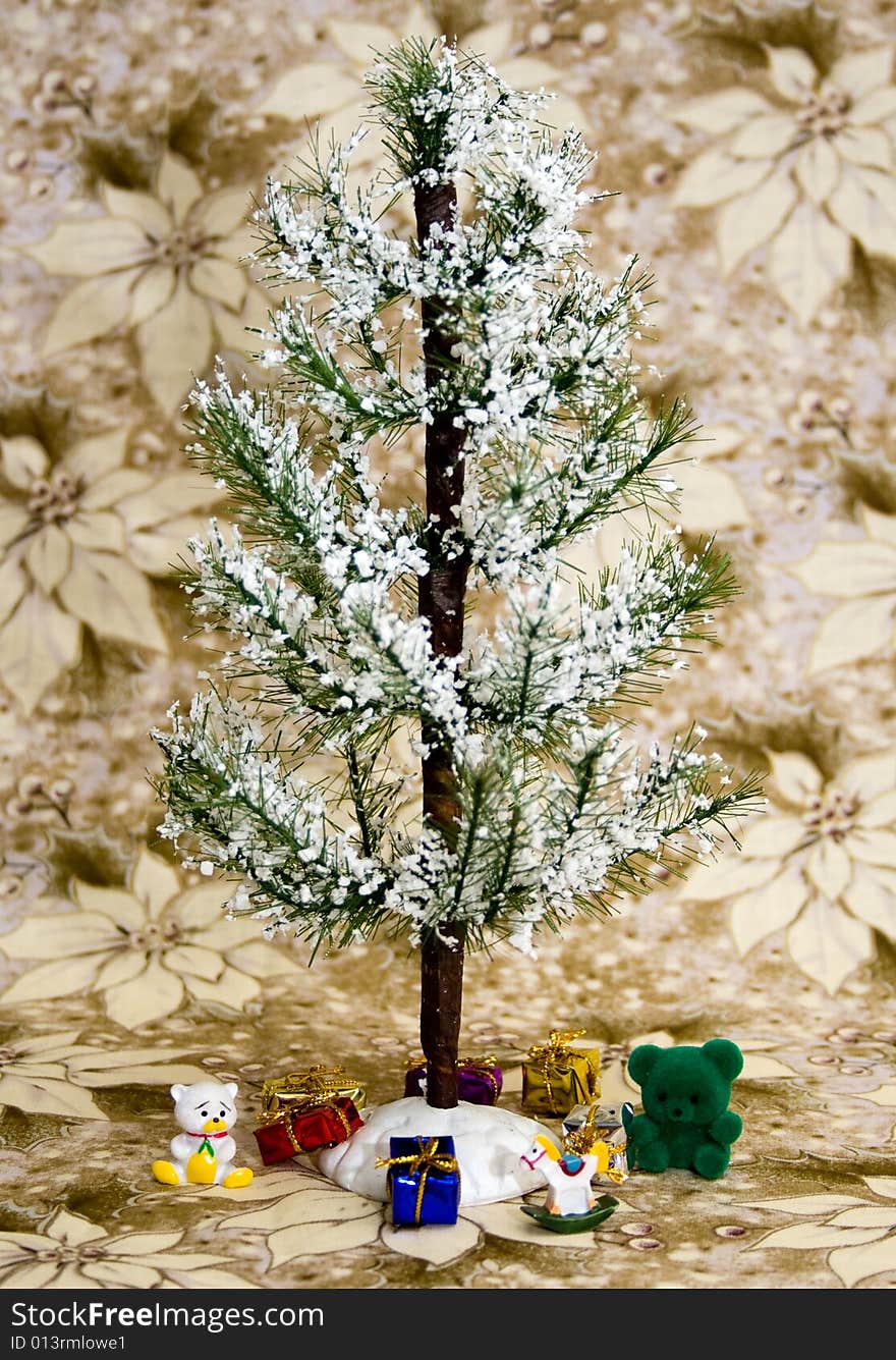 Evergreen tree with white snow. Presents and toys underneath. White/gold poinsettia flower background. Evergreen tree with white snow. Presents and toys underneath. White/gold poinsettia flower background.