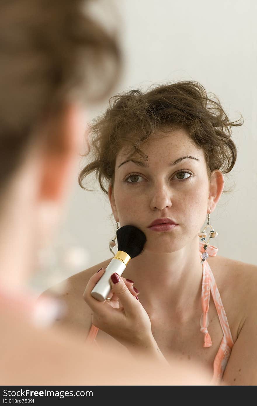 Young Beautiful Lady Makes Up Her Face