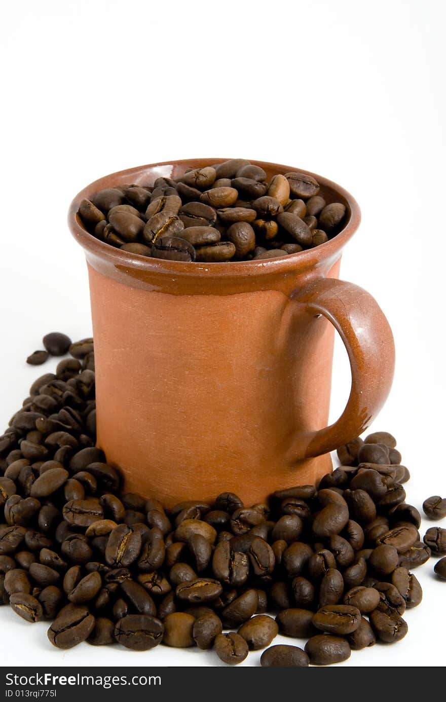 Roasted coffee and cup, white background. Roasted coffee and cup, white background.