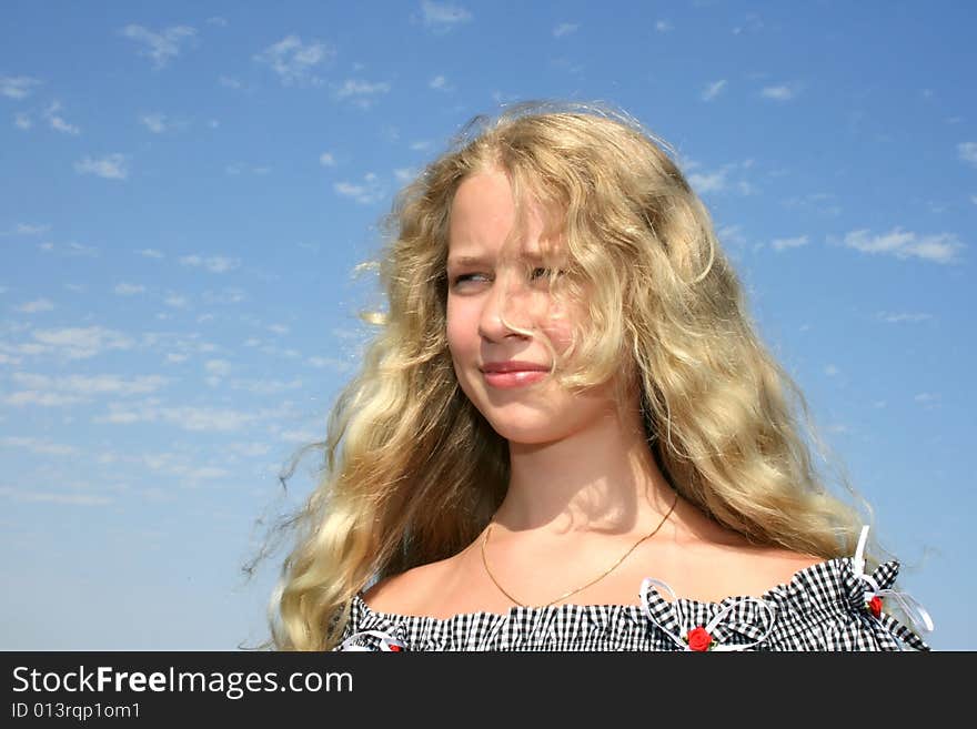 Pretty blond girl with long hair on the sky background. Pretty blond girl with long hair on the sky background.