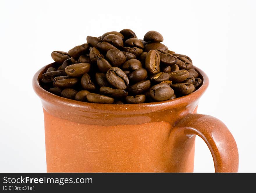 Roasted coffee and cup, white background. Roasted coffee and cup, white background.