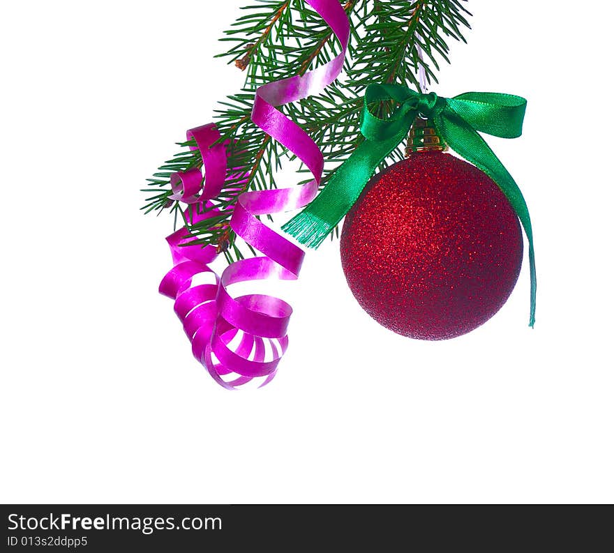 Red ball on fir branch with ribbons and bow isolated on white