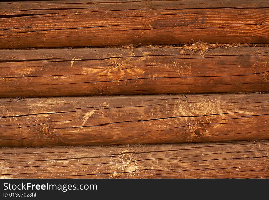 Wall of a hut from a round log