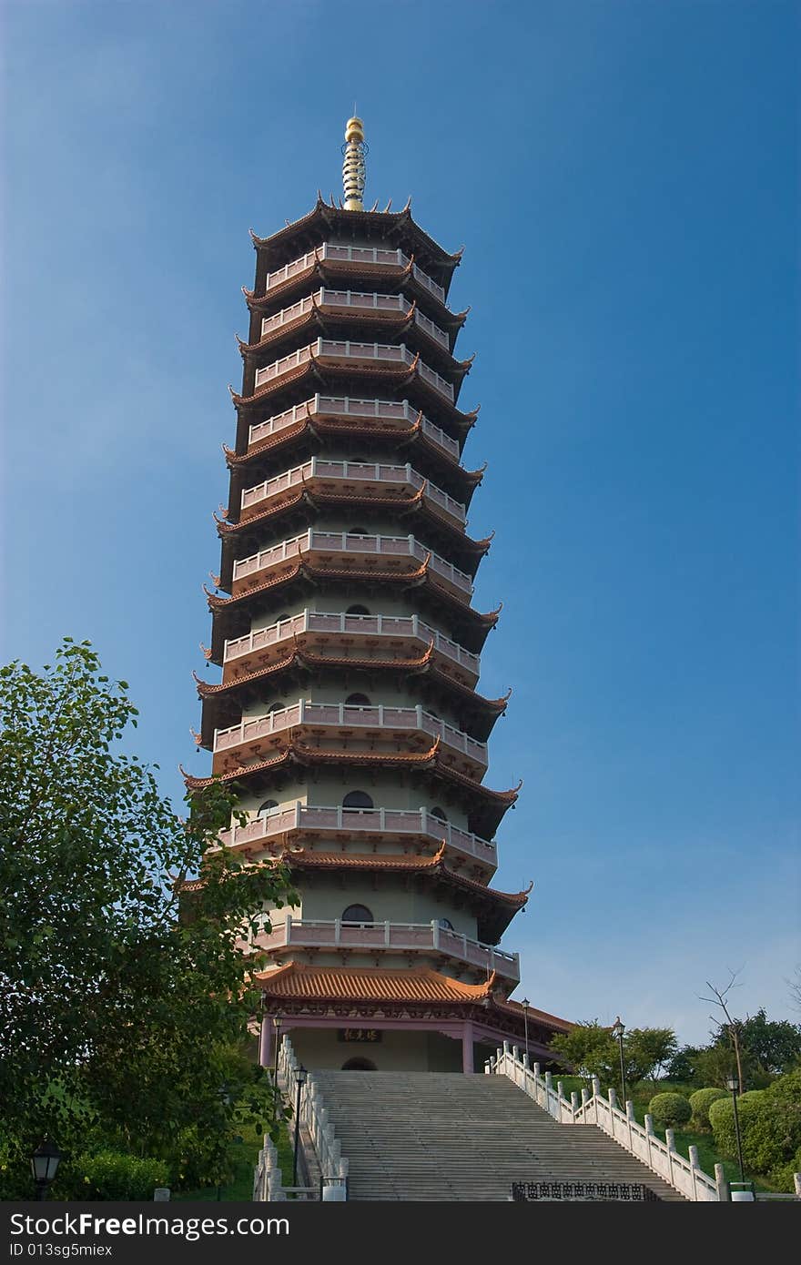 A very tall chinese style pagoda with octagonal shape