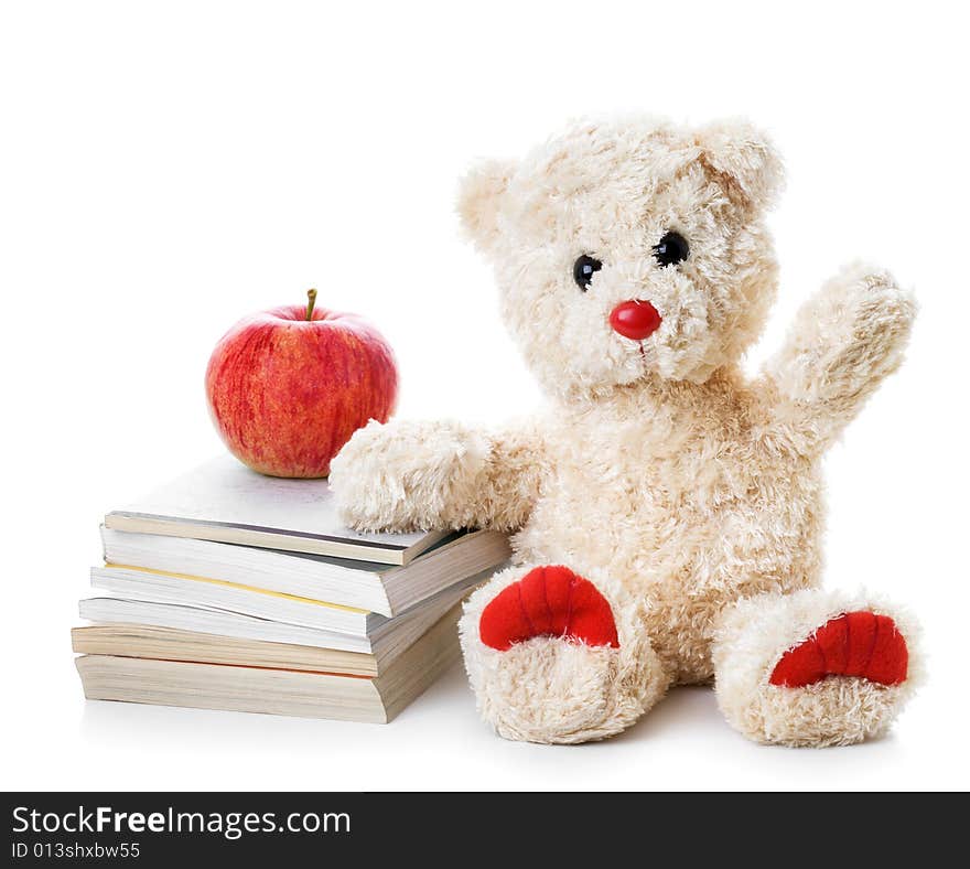 Teddy bear with a heap of books and an apple. Teddy bear with a heap of books and an apple